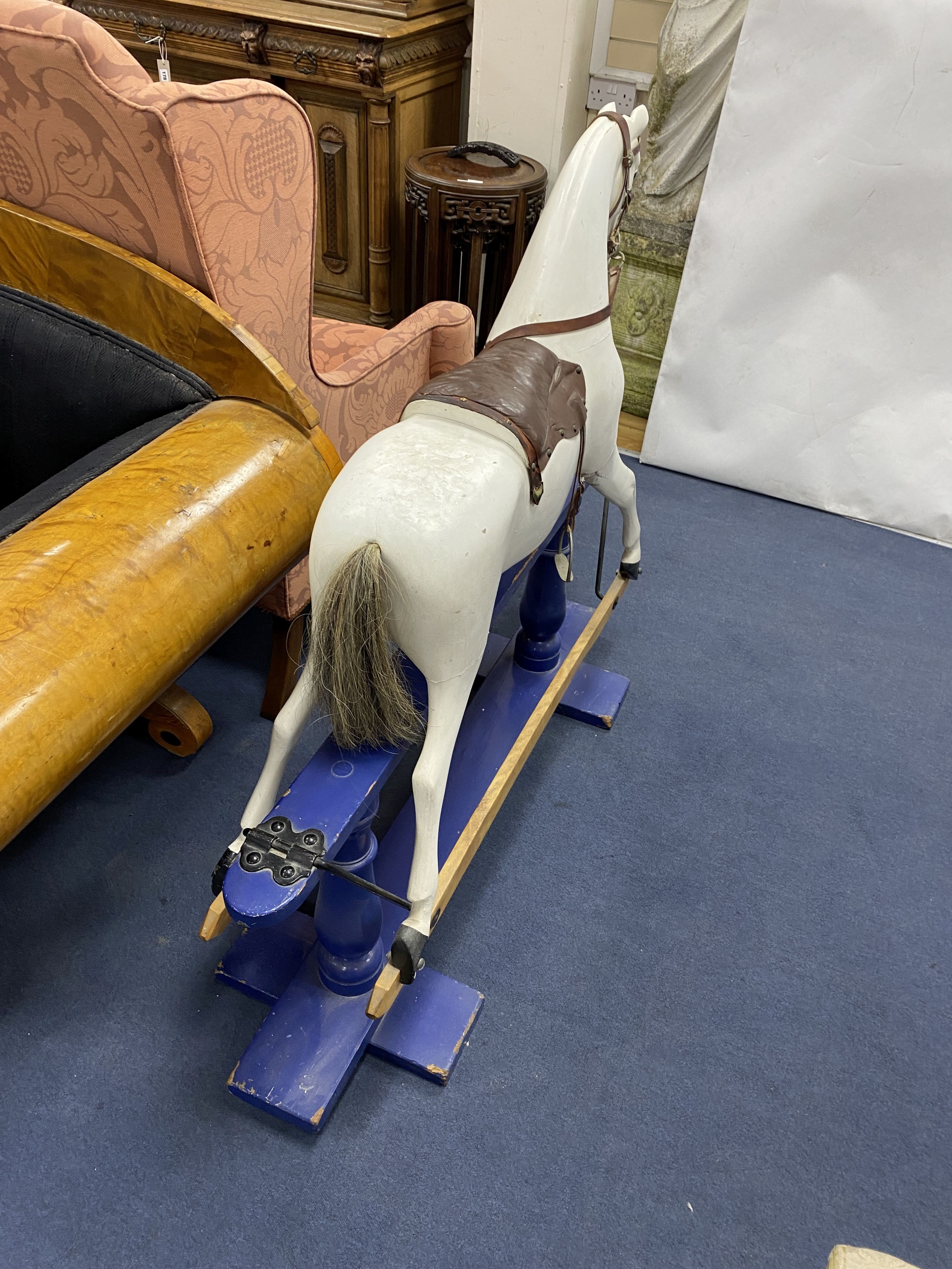 An early 20th century rocking horse on painted safety frame, (re-painted) width 126cm, height 114cm